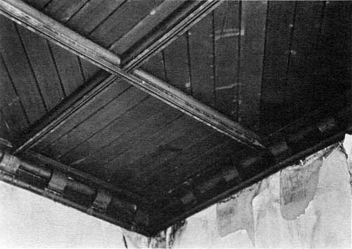 The Dining Room ceiling is comprised of diagonal and linial wood inlay panels trimmed by a backeted wood cornice.