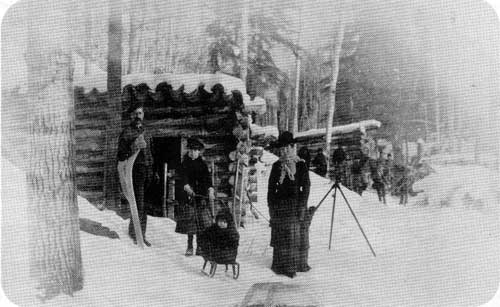 New Iceland pioneers posing in front of their log cabin in the Gimli area, no date