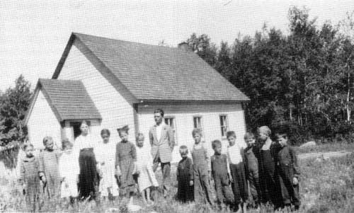 Teacher and students at Lukowce School near Gardenton, Manitoba, 1915.