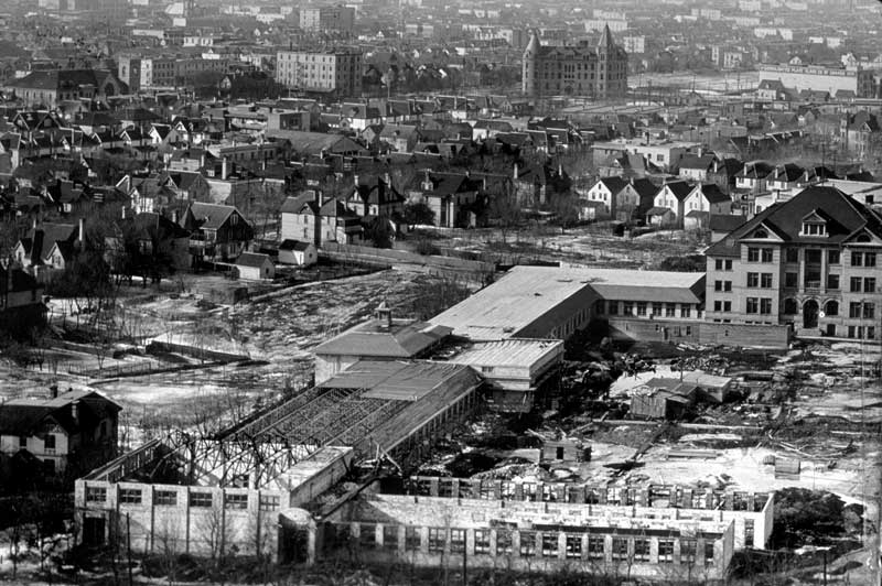 The &ldquo;temporary buildings&rdquo; under construction at the Broadway site, 1920. The original University building is on the right, and Wesley College (now Wesley Hall, University of Winnipeg) is prominent in the distance, just right of centre.