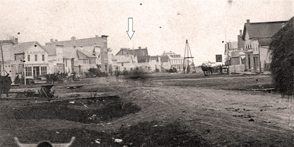 Where justice was done. A view looking northward on Main Street in 1874 shows the courthouse (arrow) where the murder trial of
Joseph Michaud was held.