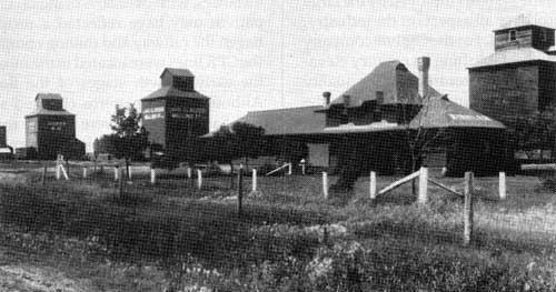 Ogilvie and Lake of the Woods Milling Company elevators at Winkler, 1916. The Winkler railway station is in the foreground.