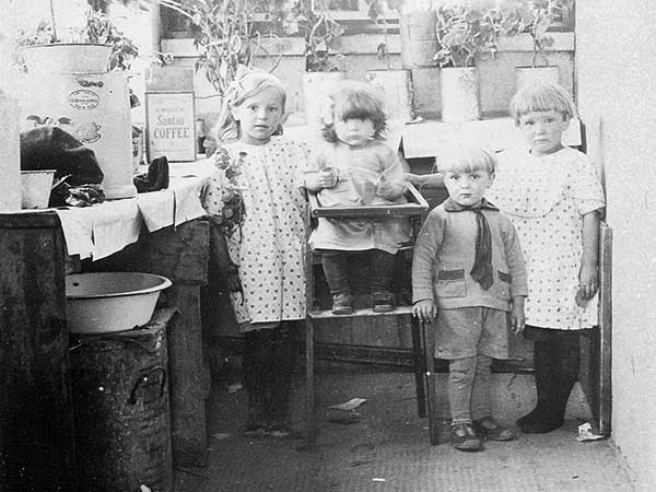 A group of Mennonite children, some of whom were probably delivered by unlicensed midwives, pose in an undated early twentieth century photograph.