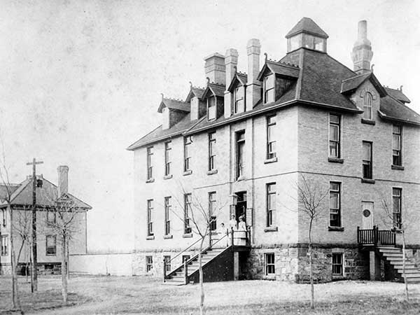 Nurses pose on the steps of the Morden Hospital, circa 1910.