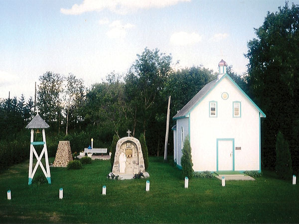 Photo of St. Michael’s Ukrainian Catholic Church, grotto and bell tower at the Trembowla Cross of Freedom site.