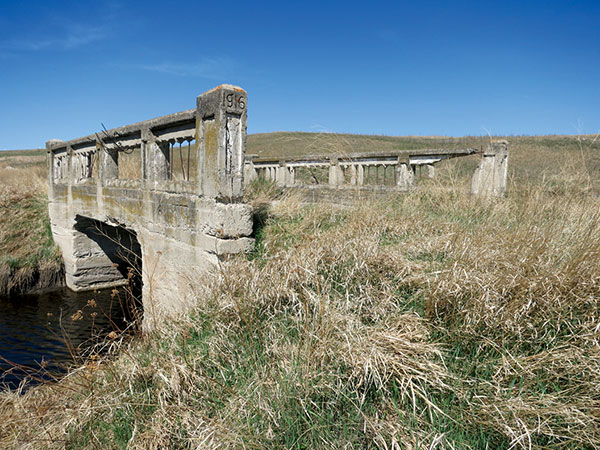 A 1916 concrete bridge in the Rural Municipality of Wallace has now been bypassed by Provincial Road 256.