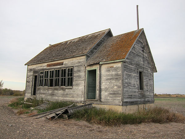 The Ewart School building still stands in the RM of Pipestone but the road that once ran past it is now a farm field.