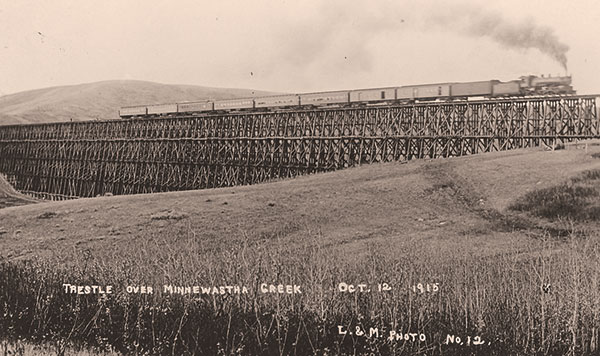 Railway service was restored over the Uno Bridge within three weeks of its destruction by a tornado. Here a GTPR passenger train crossed the reconstructed bridge on 12 October 1915.