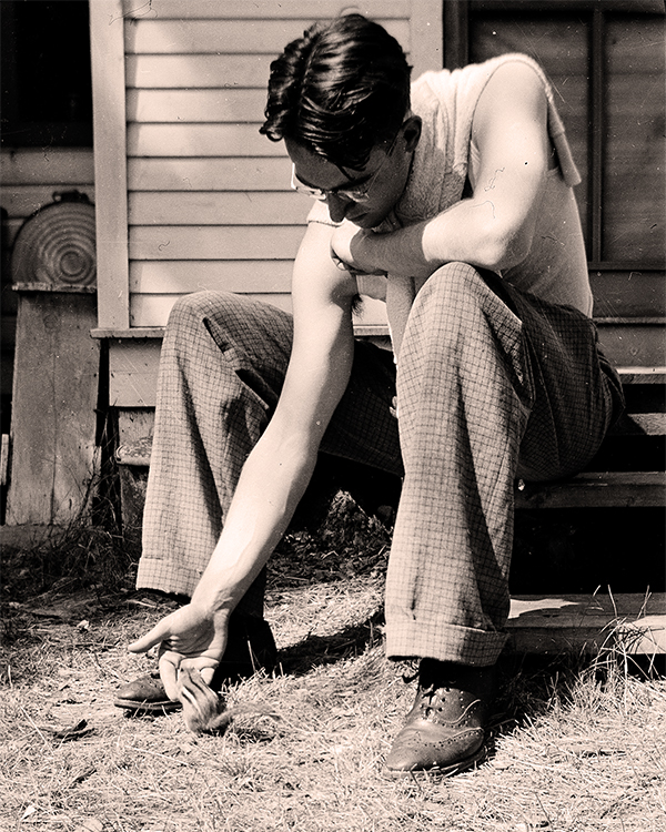 Murray Auld feeding a chipmunk, 1941