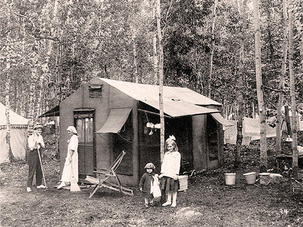 Donaldas: a quirky name for quirky little structures common in the early years of VB. Half-tent, half shed, they owed their origin to the military for field use. Much more comfortable than camping in a traditional tent, donaldas measured approximately 10 x 10 feet. They featured roofs of canvas and walls of beaverboard and screen, with 2 x 2 segmented framing over a raised wooden platform. They served new property owners for a summer or two before they could erect their permanent cottage. Unable to withstand a winter snow load, donaldas had to be collapsed in the fall but might later be refitted as bunkhouses. A few were later adapted with solid wood walls and have survived to the present.