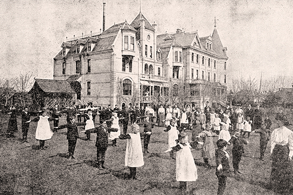 Deaf children exercise on the grounds of the Deaf and Dumb Institute, circa 1905.