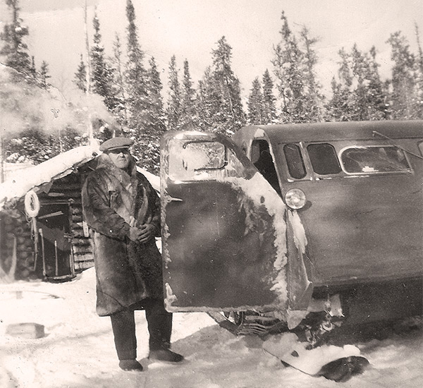 Game warden Jim Cumines (1879–1961) on winter patrol by bombardier, 1942.