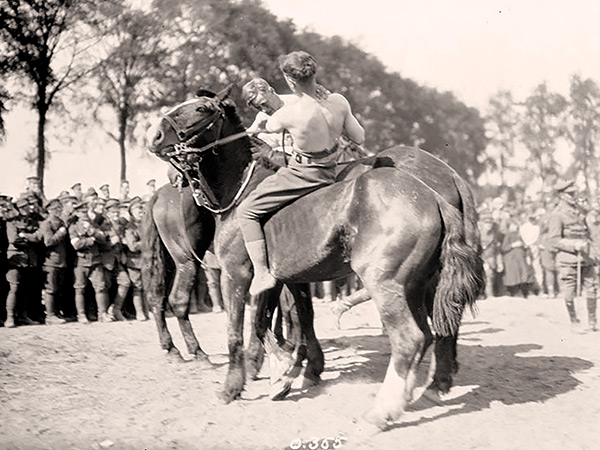 Wrestling matches on horseback, such as this one staged by members of the Canadian Expeditionary Forces during July 1916, were regular attractions at military sporting events.
