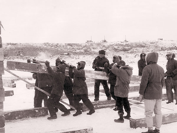 Workers construct a wooden crib at the future Kelsey Generating Station, January 1958.