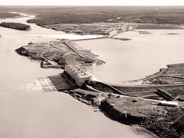 The Kelsey Generating Station with its powerhouse in the foreground and spillway in the background