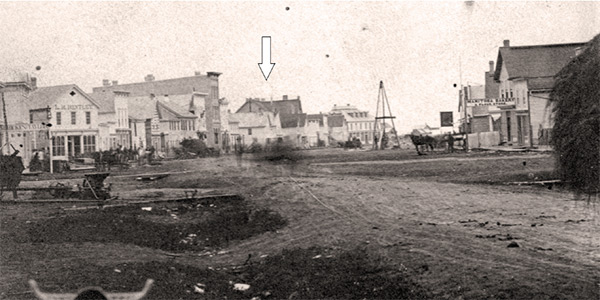 Where justice was done. A view looking northward on Main Street in 1874 shows the courthouse (arrow) where the murder trial of
Joseph Michaud was held.