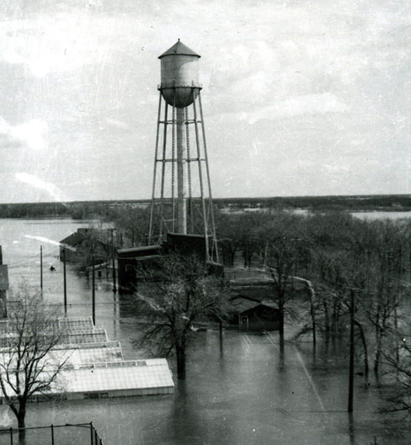 Figure 7. Water tower during 1950 flood. The two-storey building directly underneath it is the water treatment plant, and to its left is the log home of the Ireland family.