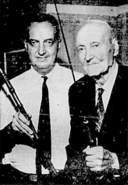 Mr. James T. Bourke (left) and Mr. John Hallett (right) with the sword.