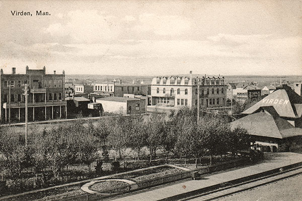 Postcard view of CPR Station at right with Alexandra Hotel at right background