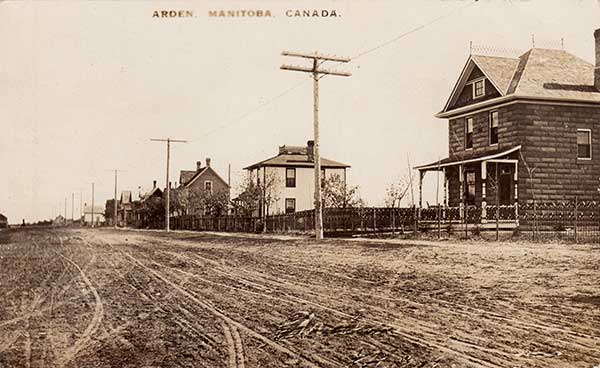 Postcard view of Arden’s main street with the concrete-block house at right