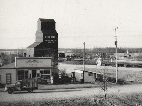 Federal Grain elevator and the Argyle General Store, as seen from a window in the Brant Consolidated School