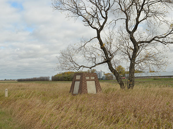 Monument in the Blumenort original cemetery listing names of people buried there