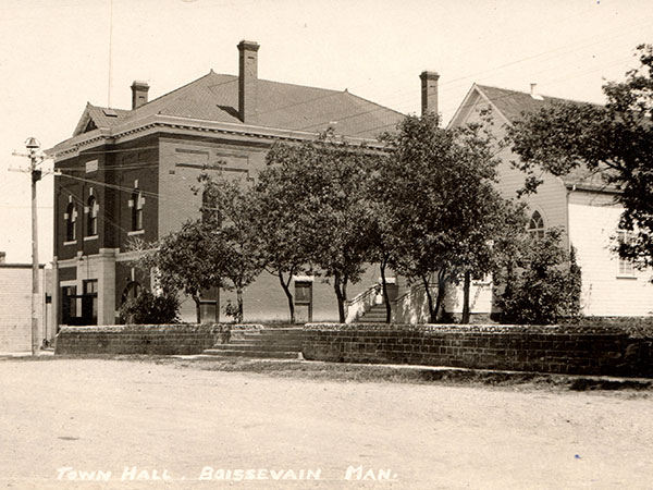 Postcard view of the Boissevain Town Hall, with St. Andrew’s Presbyterian Church at right