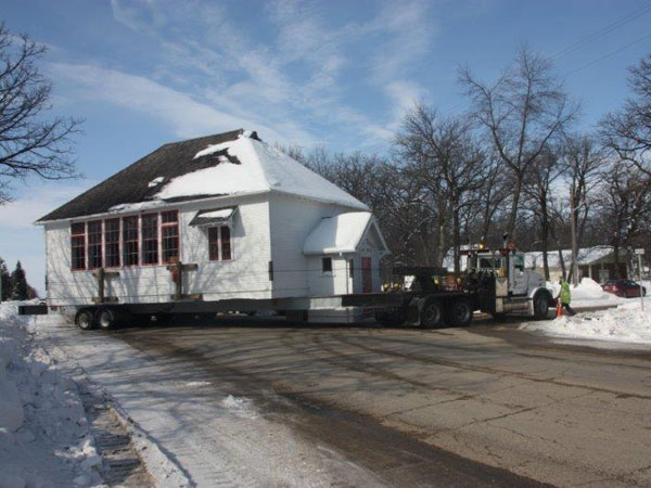 The Boyne School building being moved to the Dufferin Historical Museum