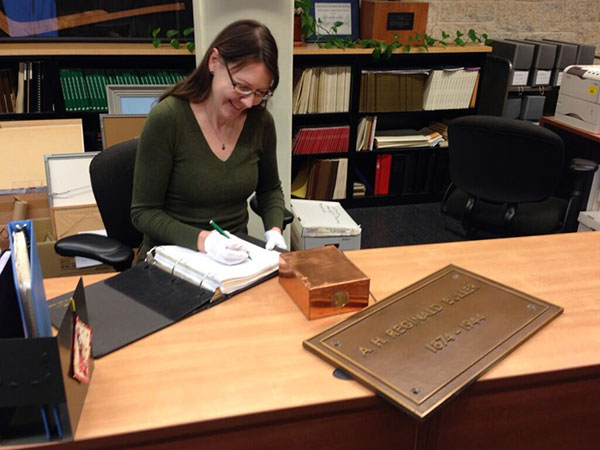 Copper box containing the Buller cremains, along with the brass wall plaque that covered the wall cavity in the now-demolished Buller Memorial Library, being accessioned at University of Manitoba Archives & Special Collections