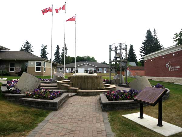 Several commemorative plaques are displayed on the grounds of the Russell municipal office