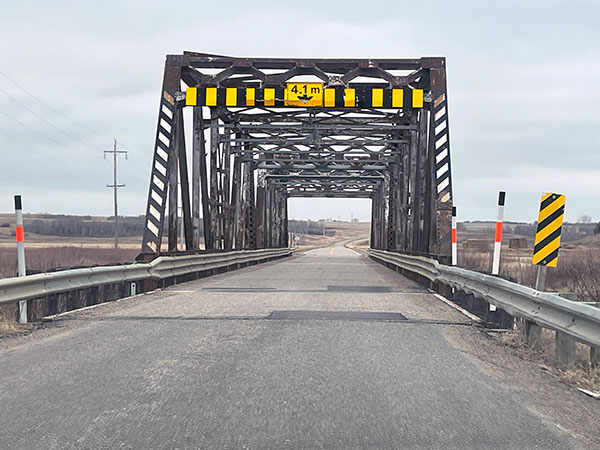 Steel through truss bridge over the Assinibone River