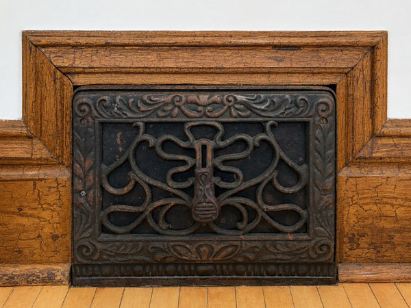 Original cast iron vent register in the Dudley House