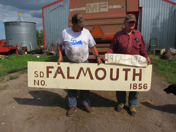 Members of the Dumanske family who saved the sign from the former Falmouth School building