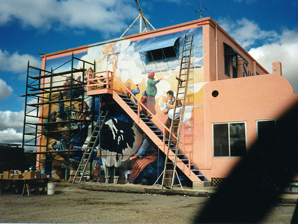 Mural being painted on the Fannystelle Hotel