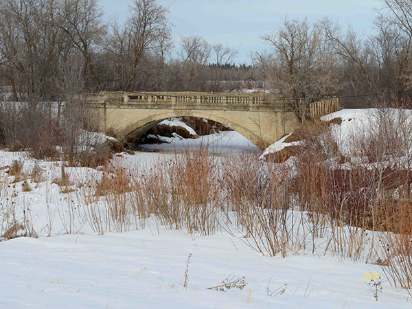 Abandoned concrete arch bridge over the South Garland Creek