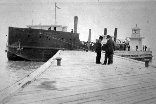 SS Rosamond Billett lying outside the breakwater at Gimli with the lighthouse at right