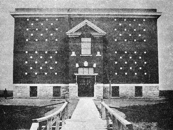 The original Governor Semple School building, constructed in 1913 and demolished in 1943. A bridge in the foregound spanned a ditch on Jefferson Avenue