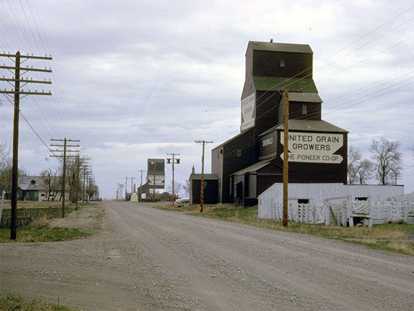 The former United Grain Growers grain elevator 2 at Griswold, with an older 3 elevator in front, both of them obtained from Ogilvie Milling, with the 1 elevator in the background