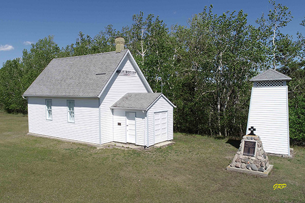 The Holy Rosary Roman Catholic Church building building and commemorative cairn