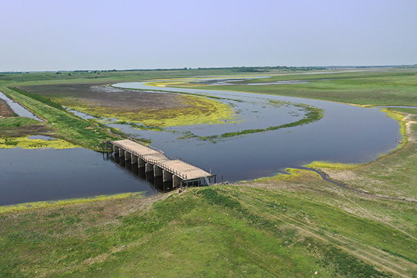 Aerial view of concrete beam bridge over Souris River