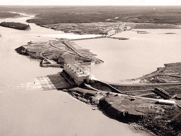 The Kelsey Generating Station with its powerhouse in the foreground and spillway in the background