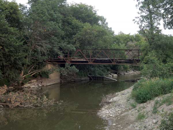 Abandoned steel pony truss bridge over the Whitemud River