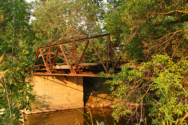 Abandoned steel pony truss bridge over the Whitemud River