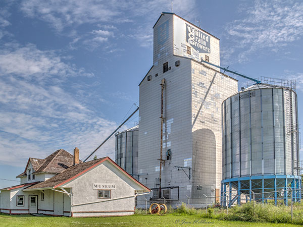 The former United Grain Growers elevator at McCreary, behind the train station now used as a community museum