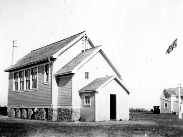 The Marquette School building with teacherage at right