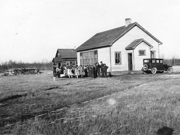 Moose Bay School and teacherage with students
