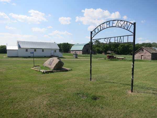 Mount Pleasant “One Six” Hall sign and monument with community hall in background