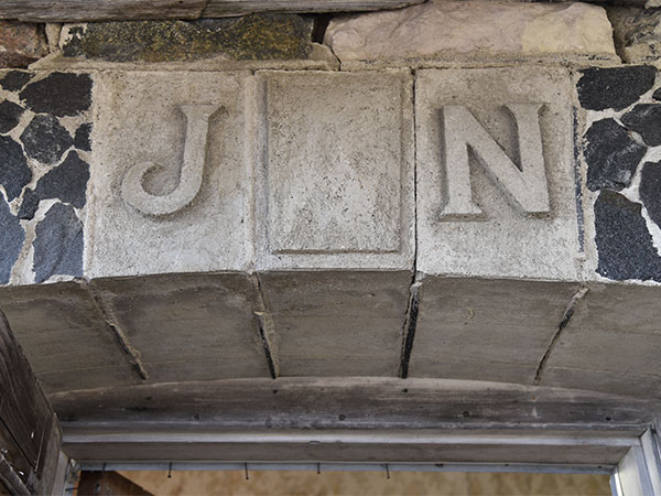 Initials of the builder, John Nicoll, above the entrance door