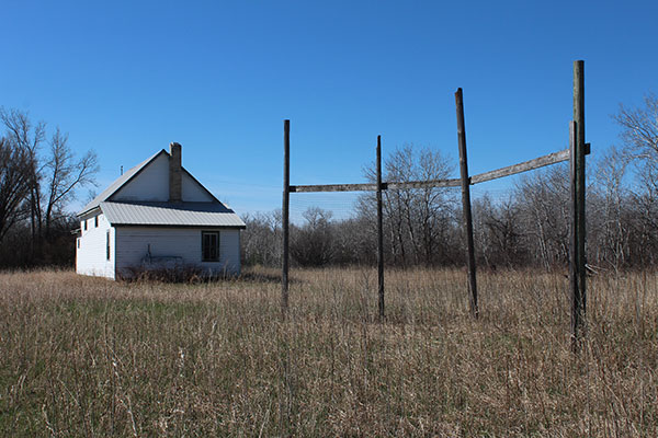 Rear view of the former Norris School building with baseball backstop