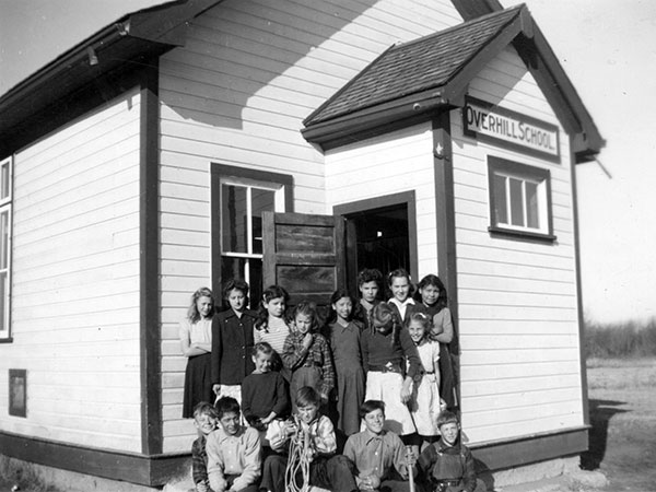Students beside the original Overhill School building